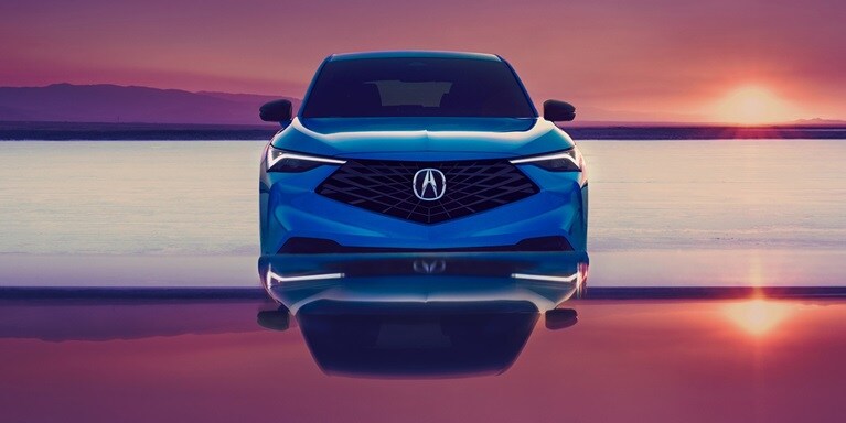 Se muestra la Acura ADX A-Spec 2026 en Double Apex Blue Pearl II, estacionada con una puesta de sol en el fondo.