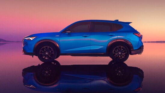 Perfil de la Acura ADX 2026 en Adriatic Sea Blue Metallic en salinas al atardecer con reflejos (SUV compacta prémium).